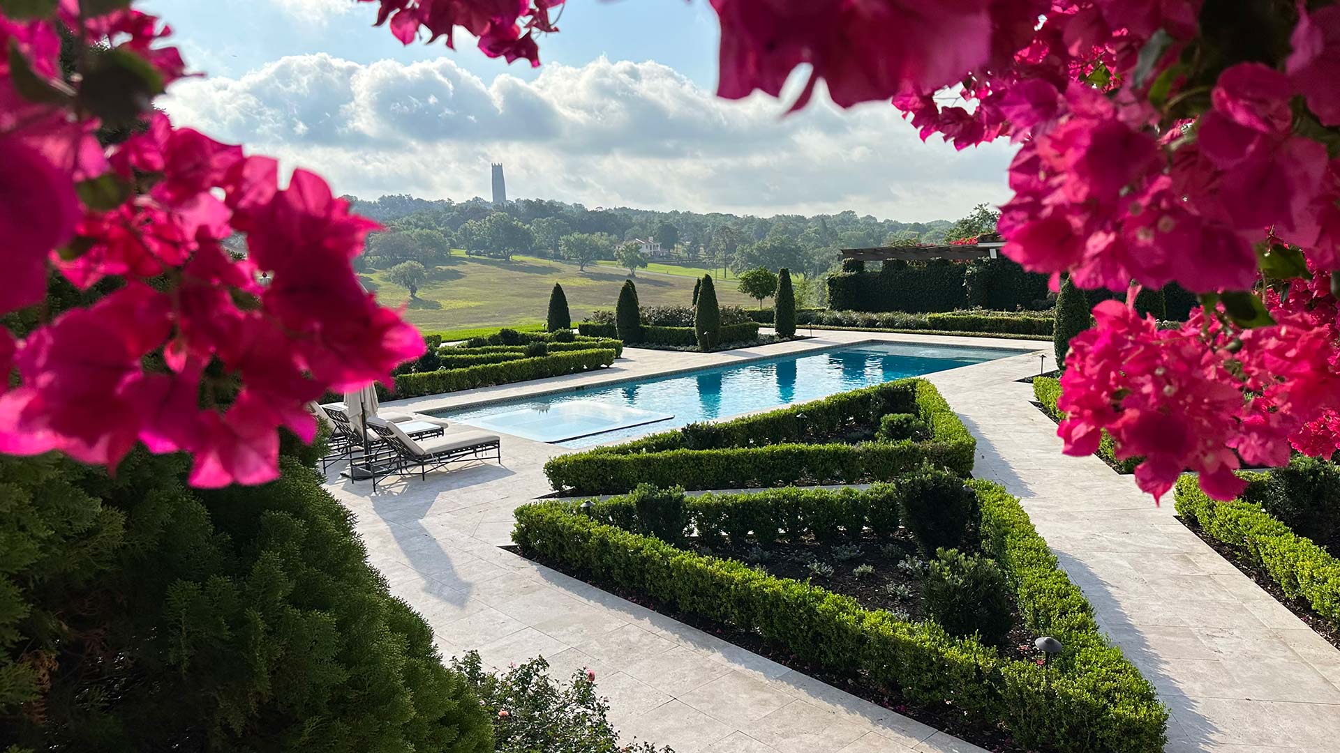 Bougainvillea flowers and other landscaping installed around a pool in Bartow, FL.