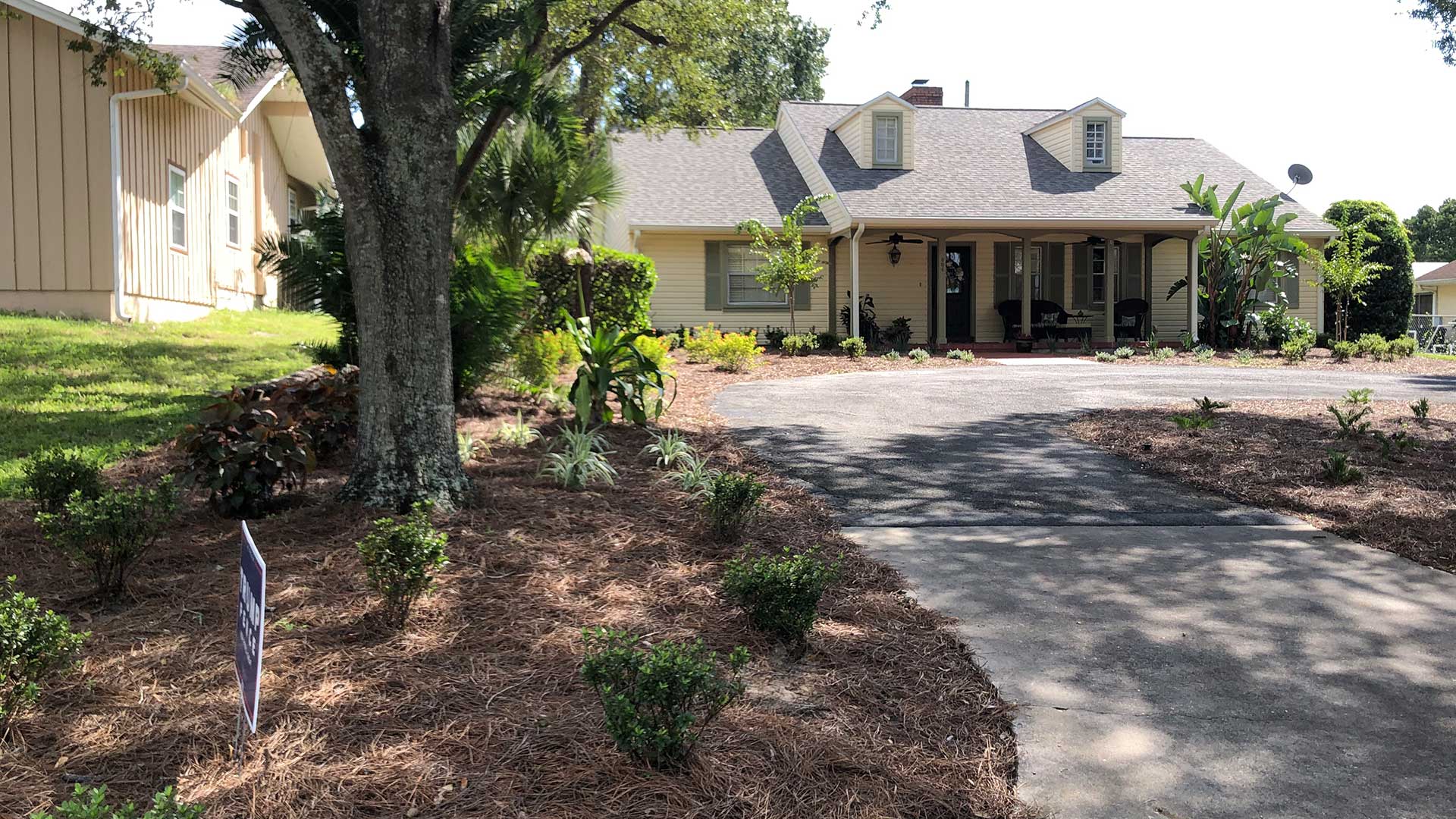 New landscape installation at a home in Lakeland Highlands, FL that includes plants, shrubs, flowers, and new mulch.